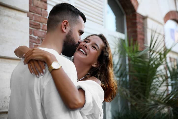 happy couple embracing outdoors summer