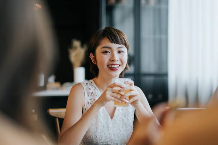 Woman having fun and enjoying food and drinks with friends.