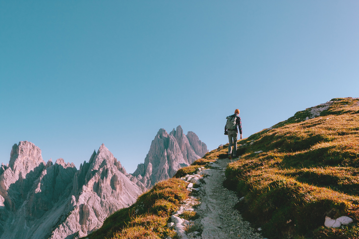Man climbing up a mountain.