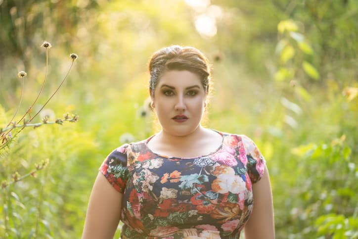 picture of a curvy woman in a field