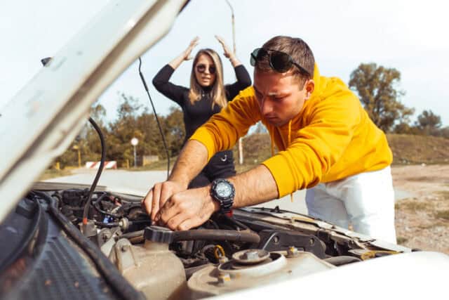 couple fighting over broken car