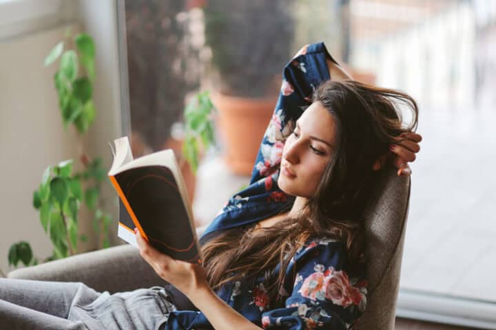 Young woman reading at home