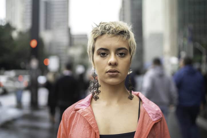 non-binary woman facing camera