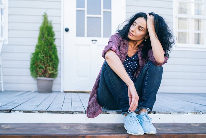 sad woman sitting on a porch