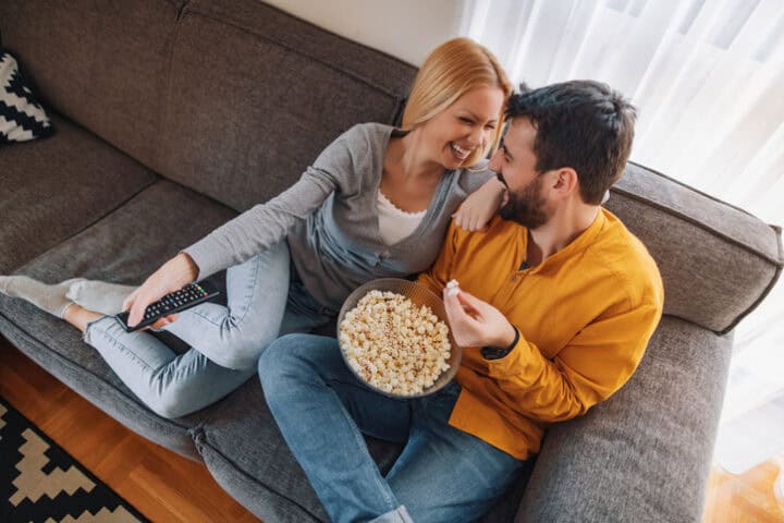couple at home with popcorn