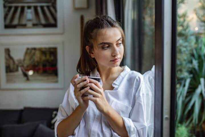 young woman looking out of the window