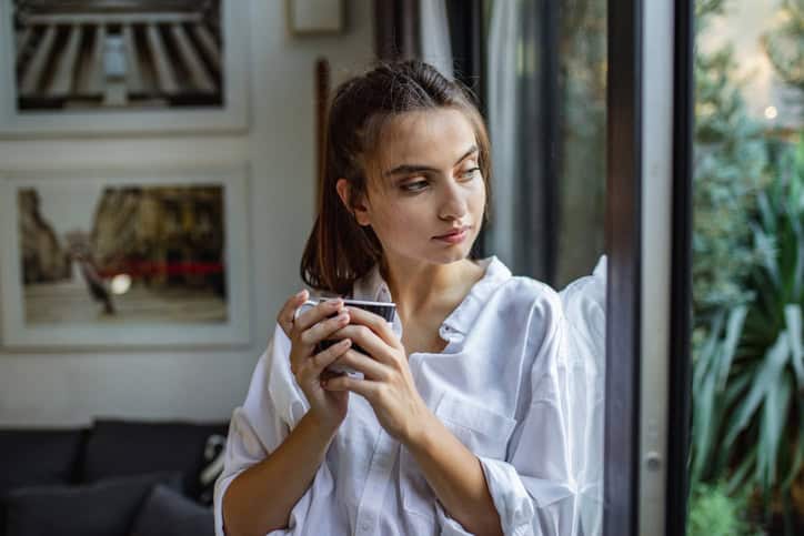 young woman looking out of the window