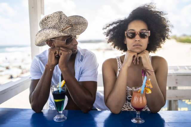 angry woman at beach with boyfriend