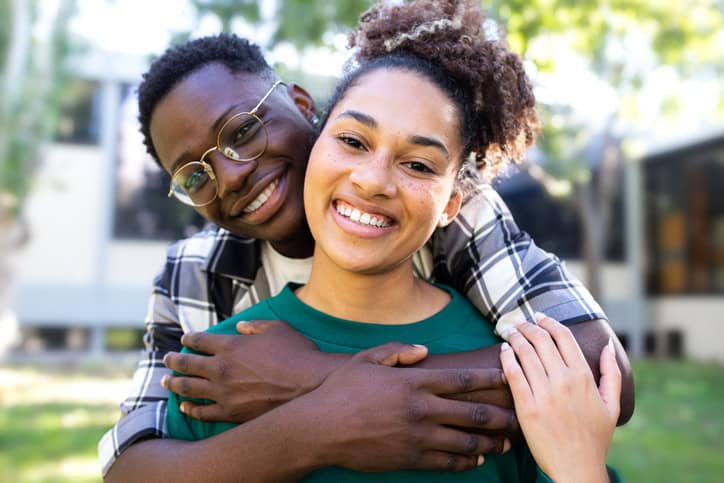 smiling couple embracing outdoors