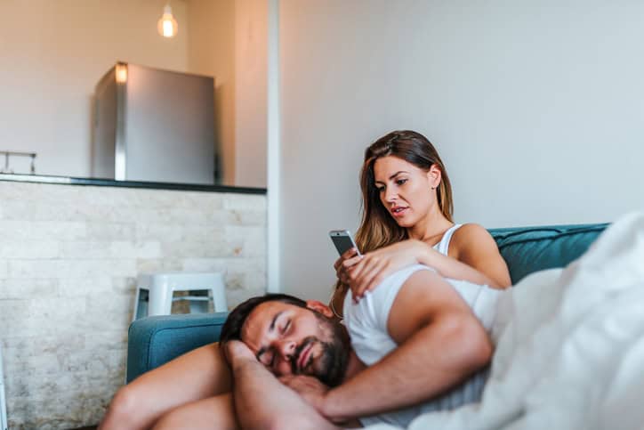 woman checking boyfriend's phone