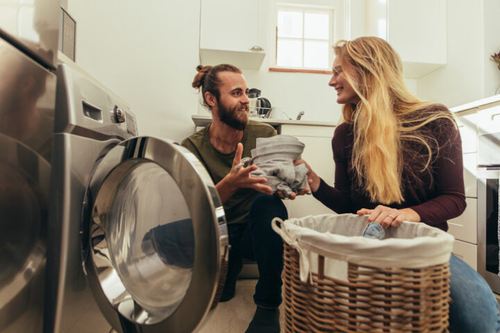 Couple doing laundry together.