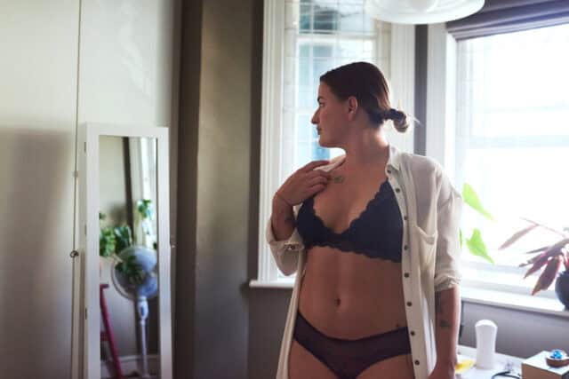 woman looking at herself in mirror