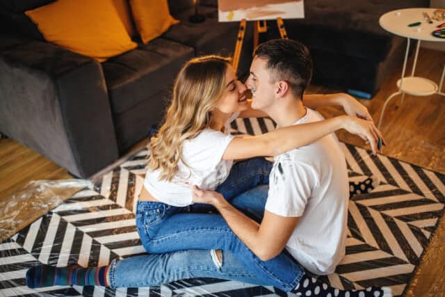 sweet couple kissing on rug