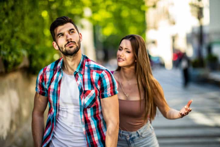 Couple arguing outside.