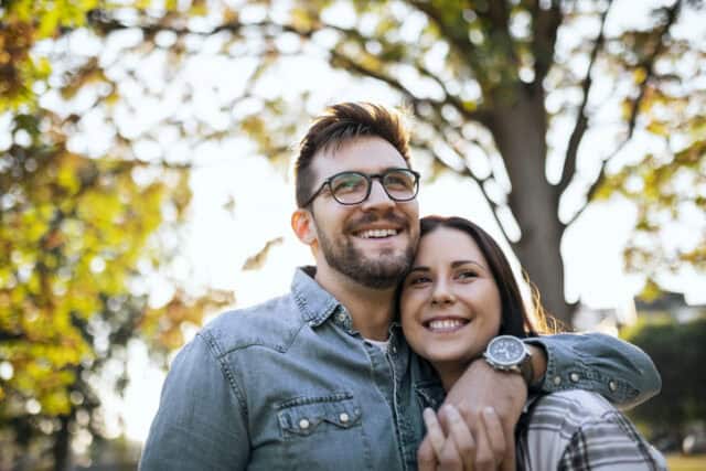 smiling couple posing autumn day