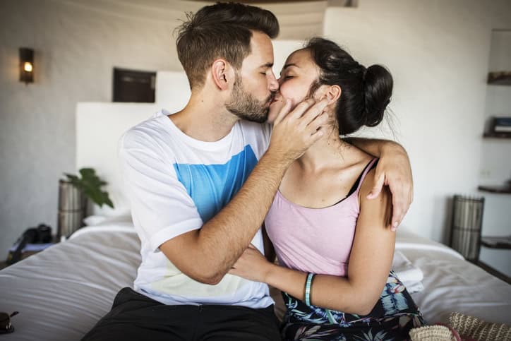 couple kissing bedroom