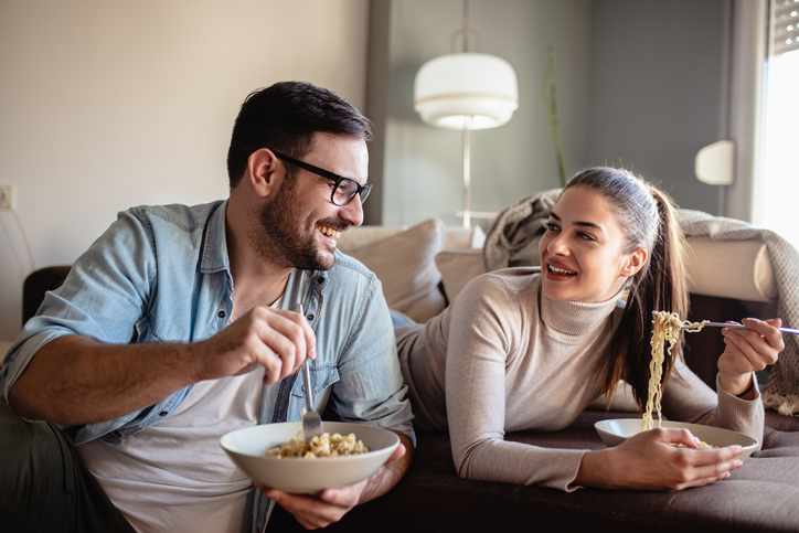 Couple eating noodles.