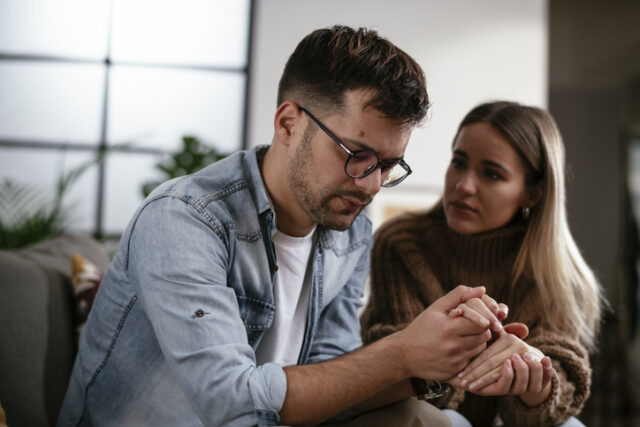 woman comforting upset boyfriend