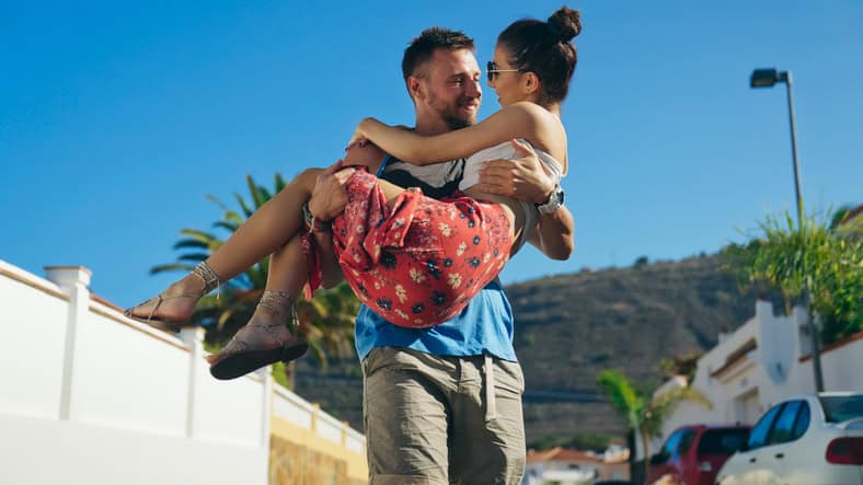 romantic man holding woman outdoors