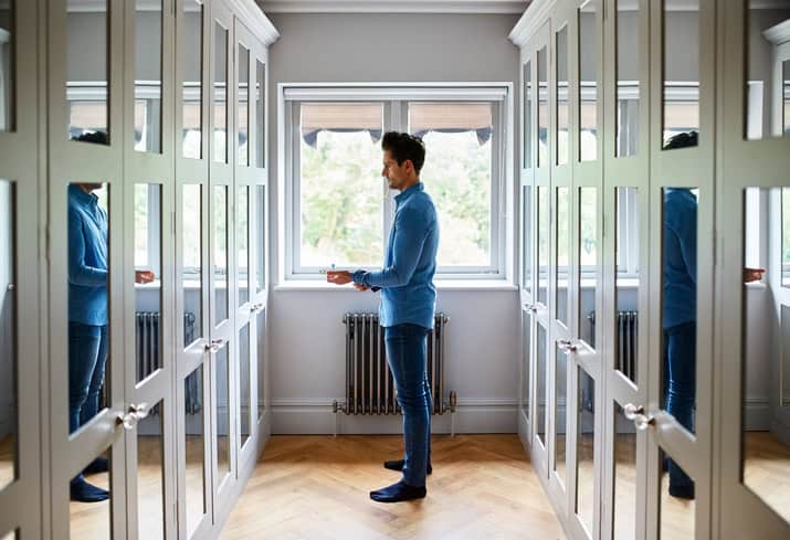 man getting dressed in mirror
