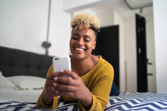 woman taking selfie in bed
