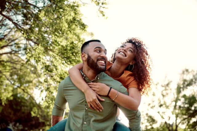 woman riding piggyback on boyfriend