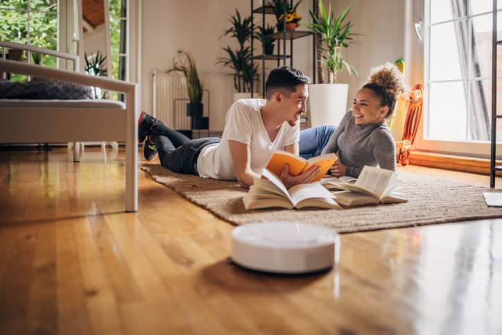 intelligent couple reading on floor