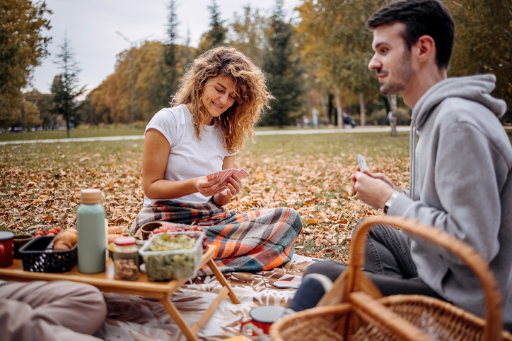 A couple sharing romantic autumn picnic.