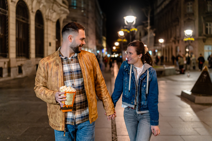 Couple holding hands on a date.