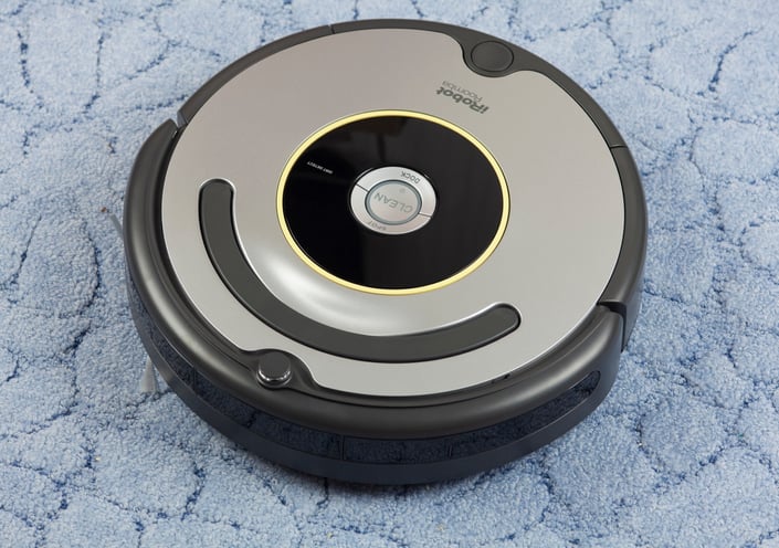 iRobot vacuum on rug.