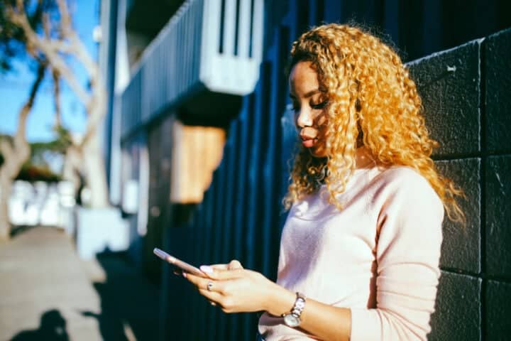 annoyed woman texting outdoors