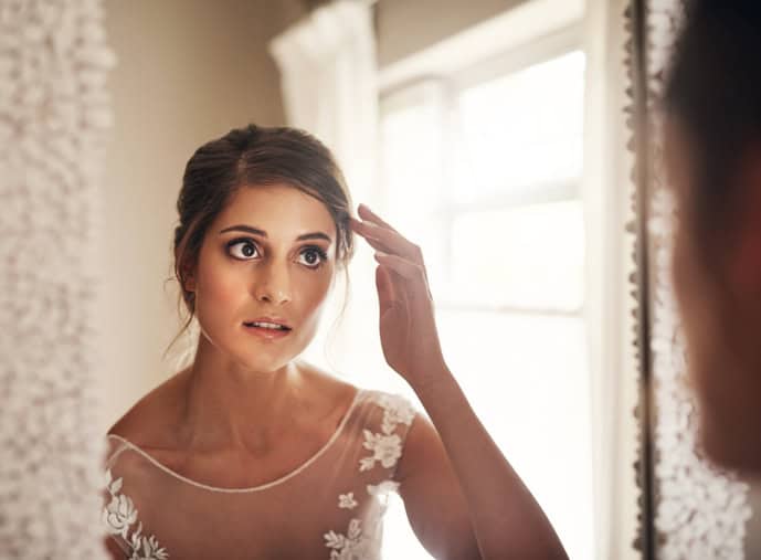 nervous bride looking in mirror