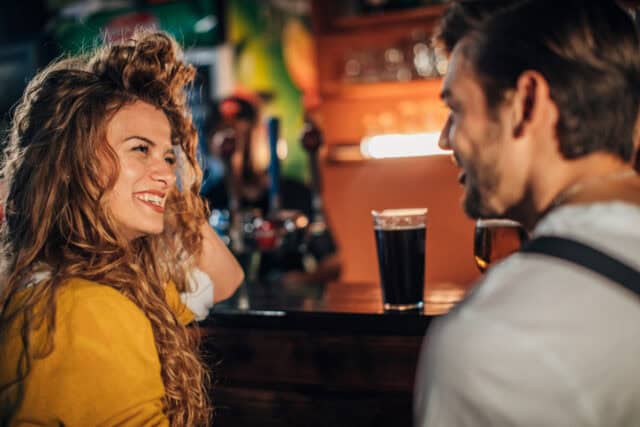 couple flirting at bar
