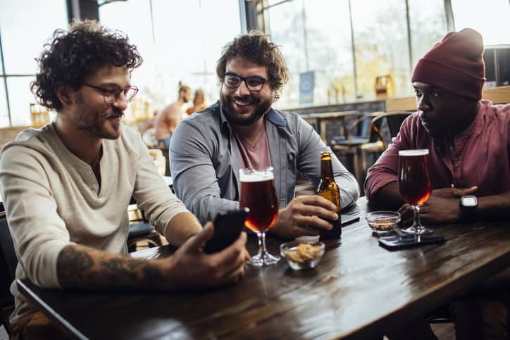 guy friends drinking at bar