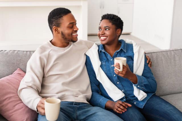 happy couple sitting on couch