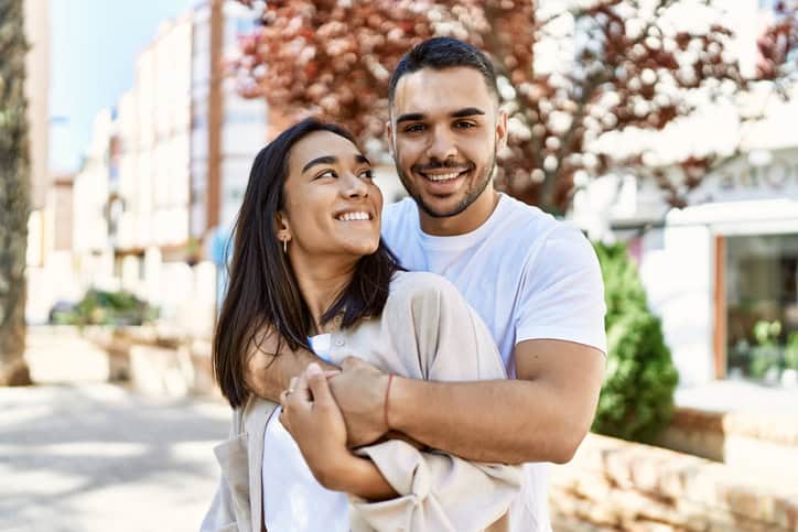 happy couple embracing outdoors