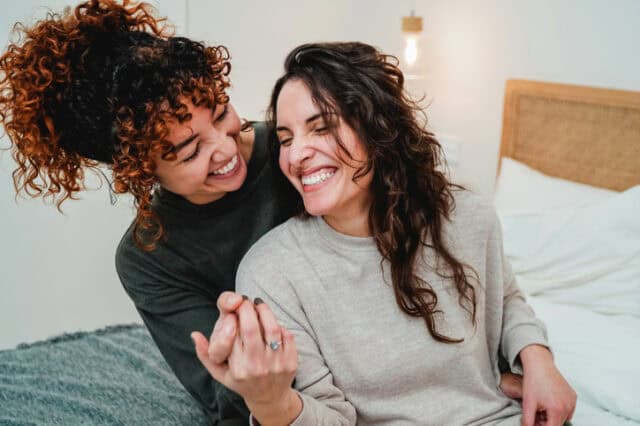 happy lesbian couple in bed