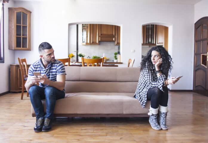 unhappy couple sitting on couch