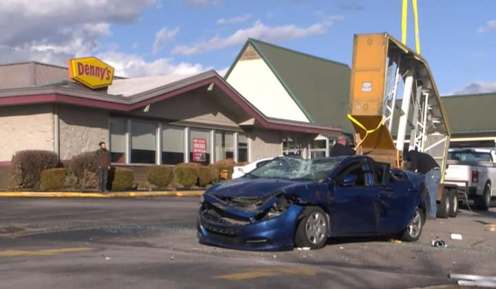 denny's sign falls on car