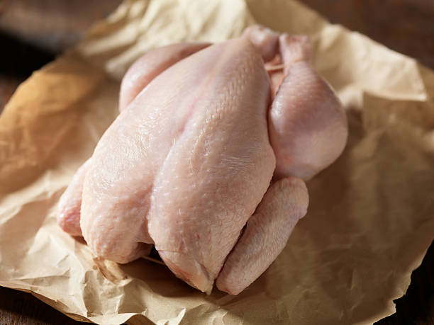 Raw whole chicken ready to be cooked.