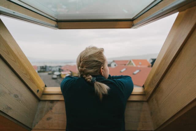 woman looking out paris window