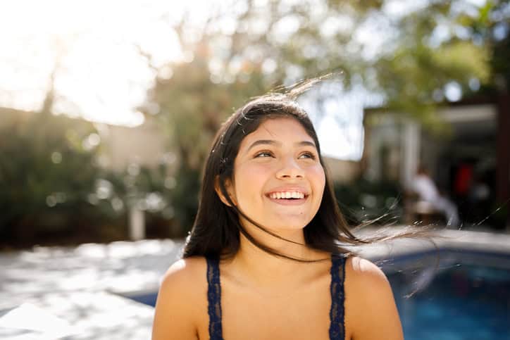 smiling brunette girl in sunshine