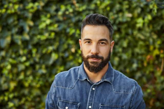 guy standing in front of foliage