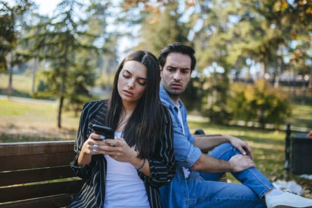 man looking at woman's texts
