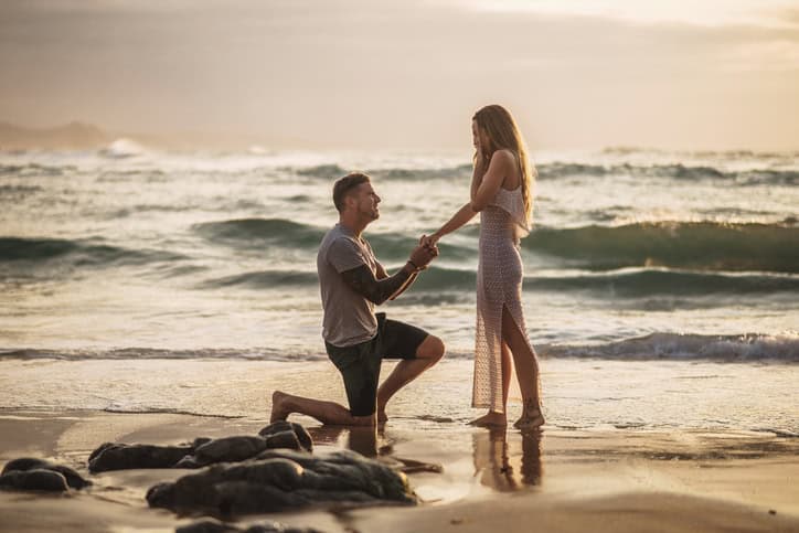 man proposing at beach