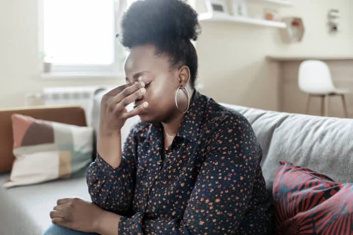 frustrated woman pinching nose