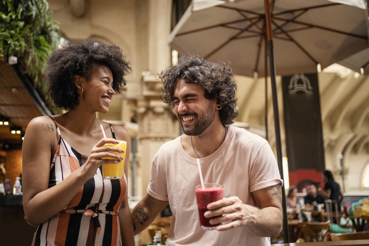 Tourists drinking juice in the municipal market of São Paulo.
