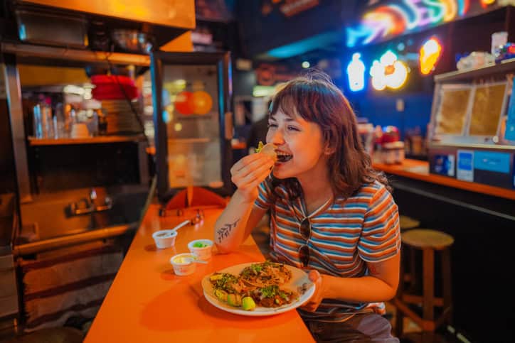 happy women eating at taco bar