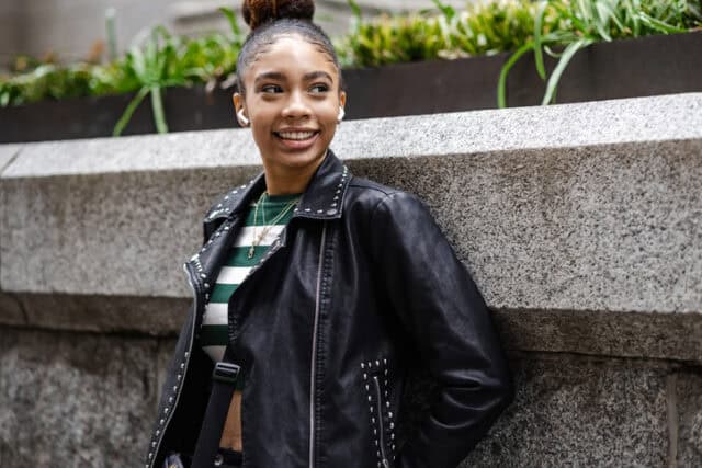 smiling young black woman with airpods