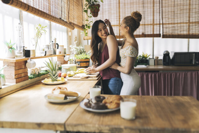 lesbian couple preparing meal together